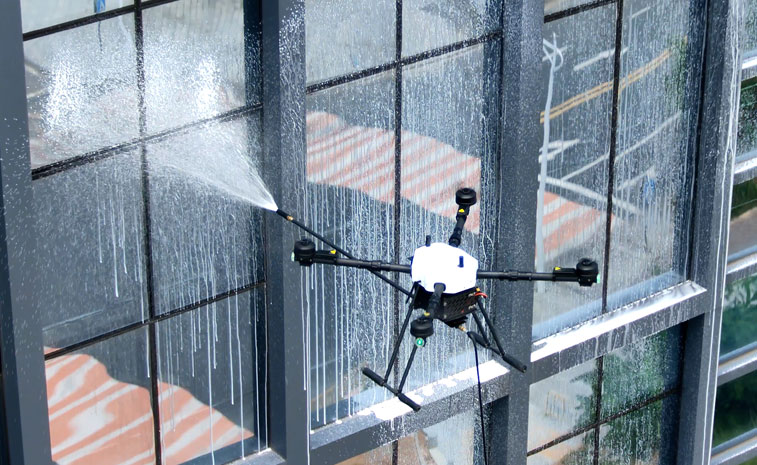 Drone window cleaning high-rise building with pressure washer Drone window cleaning high-rise building with pressure washer