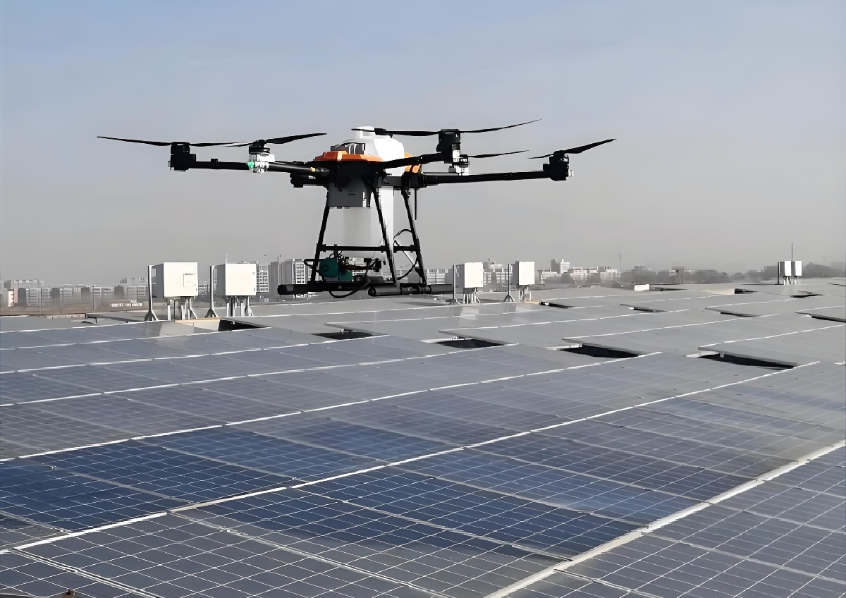 Solar panel cleaning drone hovering above commercial photovoltaic array Solar panel cleaning drone hovering above commercial photovoltaic array