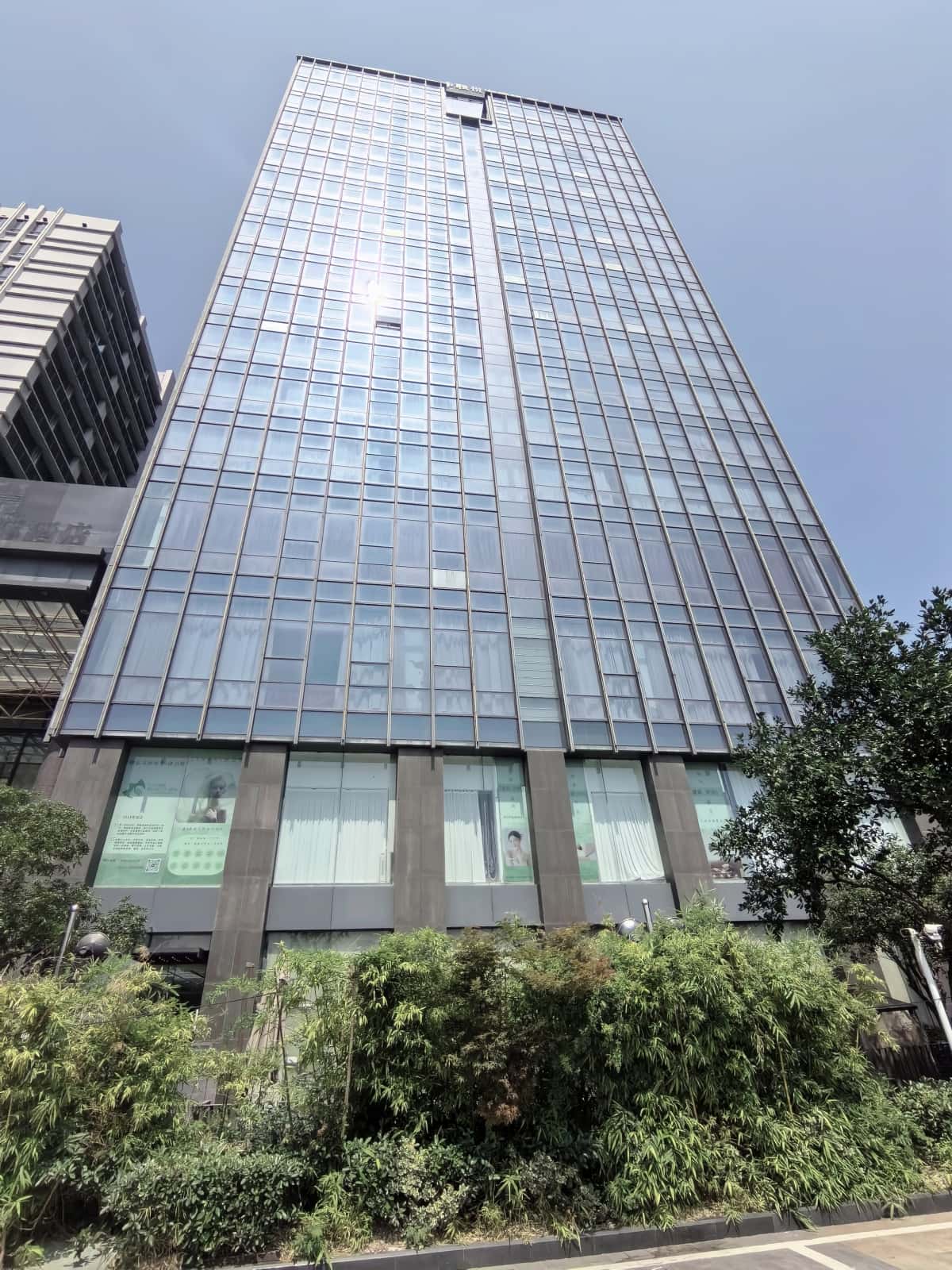 Drone window cleaning service in action – modern cleaning drone washing high-rise building glass Drone window cleaning service in action – modern cleaning drone washing high-rise building glass