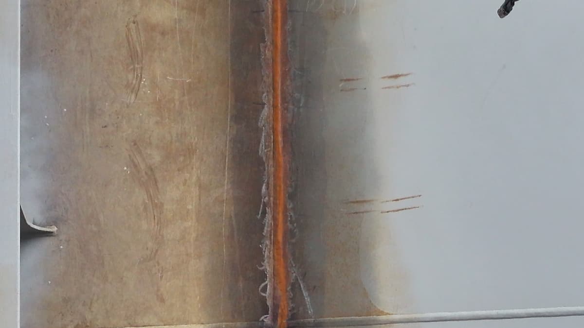 DJI Matrice drone performing automated bubble testing on ship hull welds for leak detection