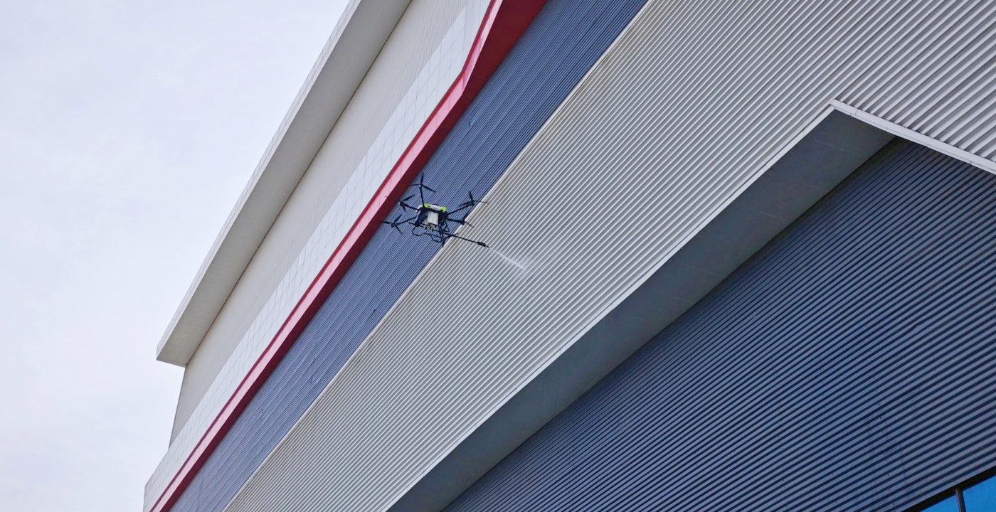 C40A window cleaning drone spraying glass curtain wall of skyscraper C40A window cleaning drone spraying glass curtain wall of skyscraper