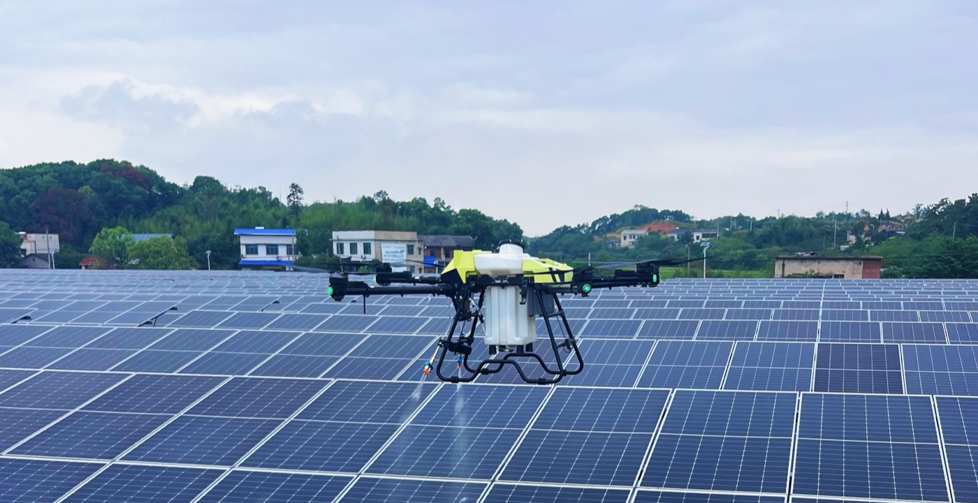  C40B drone cleaning solar panels on industrial rooftop array