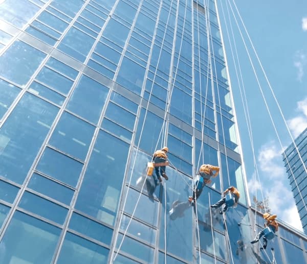 DJI Matrice M400 industrial drone fitted with modular cleaning kit cleaning glass facade of high-rise building DJI Matrice M400 industrial drone fitted with modular cleaning kit cleaning glass facade of high-rise building