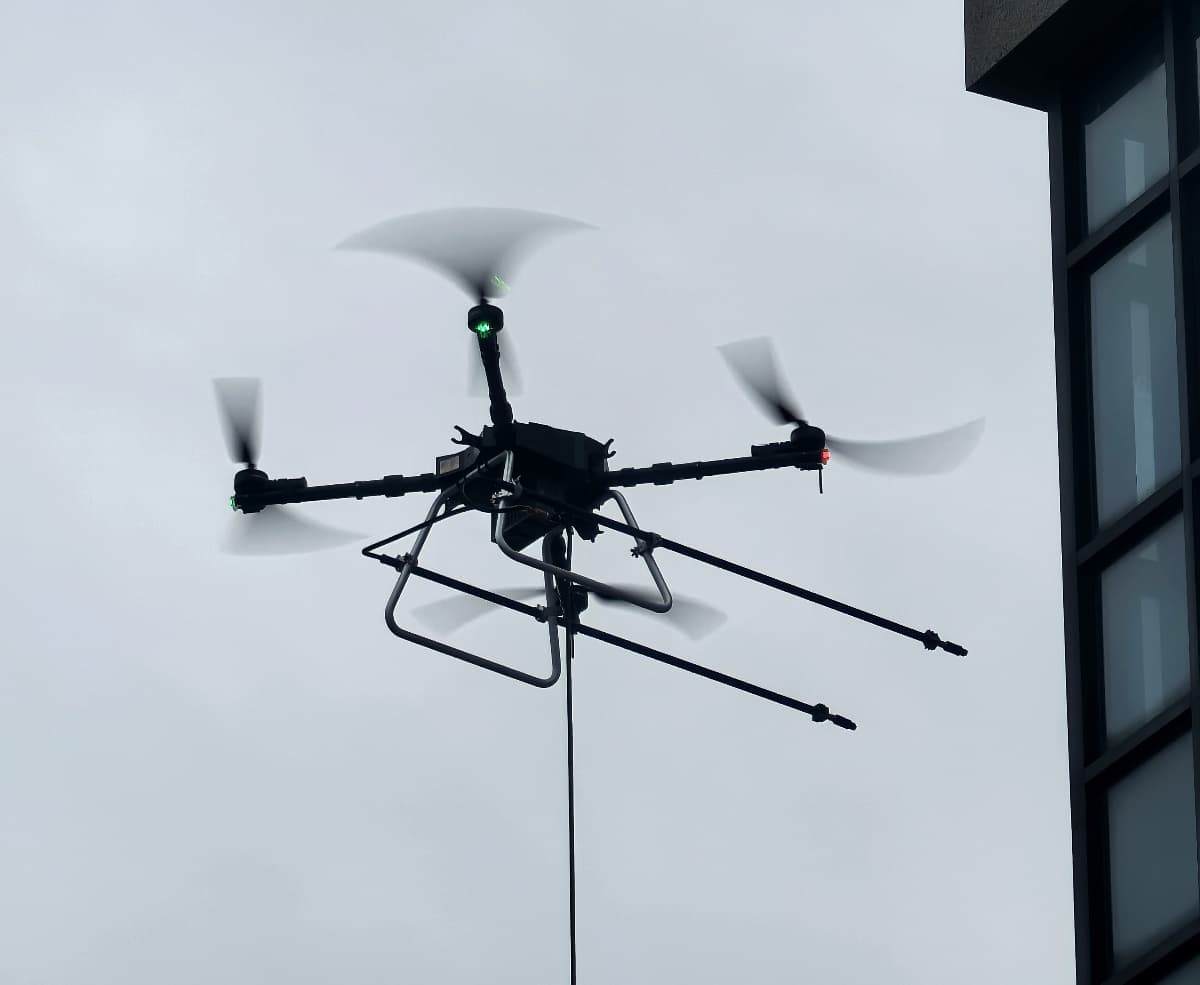 C40A window cleaning drone spraying glass curtain wall of skyscraper C40A window cleaning drone spraying glass curtain wall of skyscraper