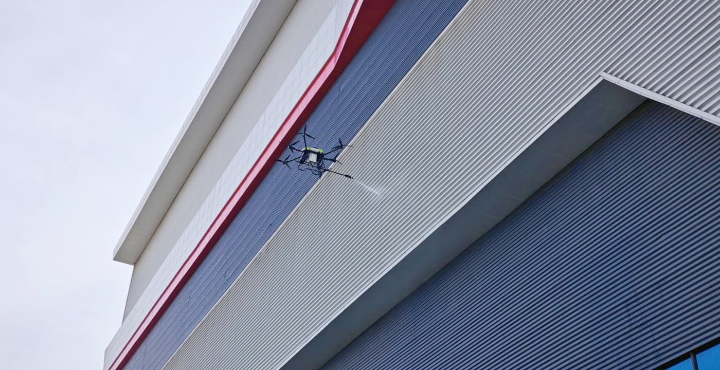 C40A window cleaning drone spraying glass curtain wall of skyscraper C40A window cleaning drone spraying glass curtain wall of skyscraper