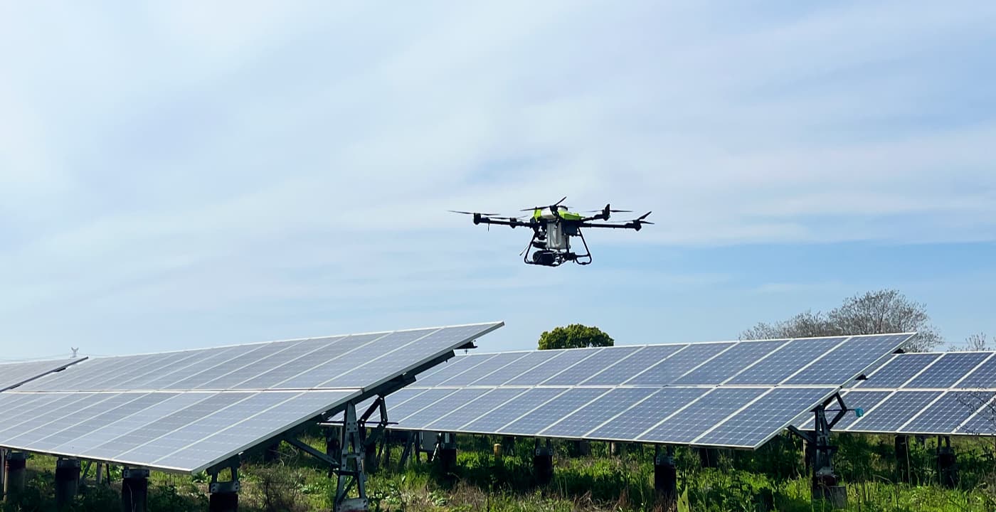 C40B drone cleaning solar panels on industrial rooftop array C40B drone cleaning solar panels on industrial rooftop array