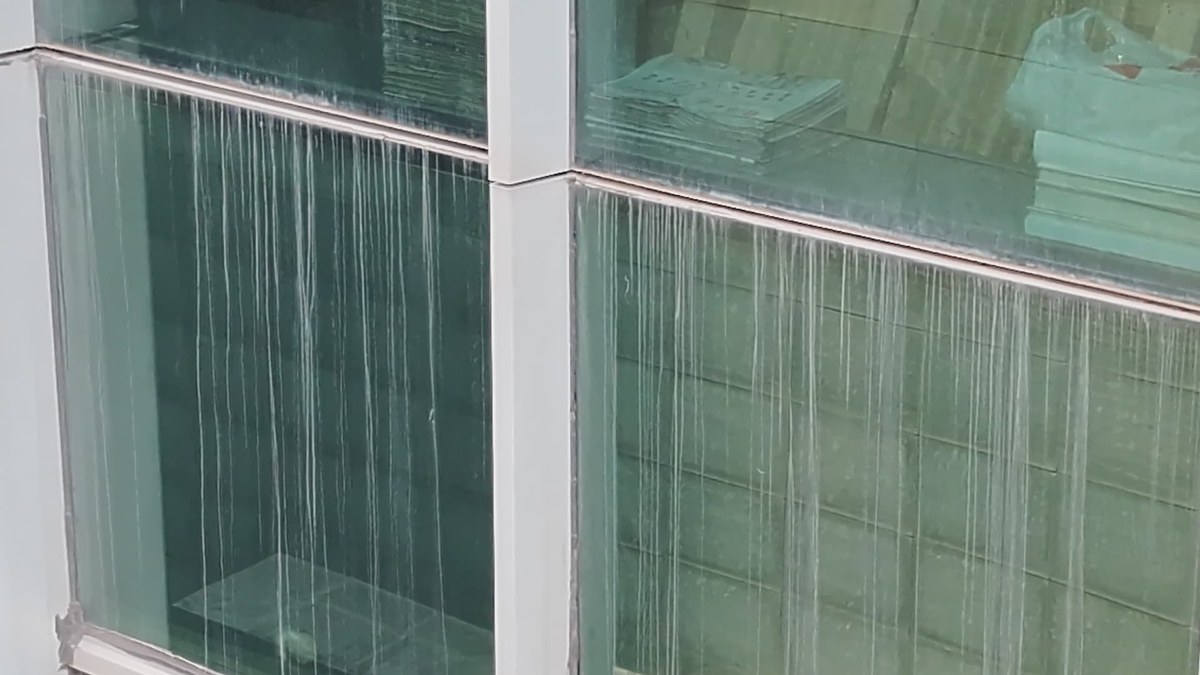 Aerial view of a glass curtain wall high-rise tower before drone facade cleaning Aerial view of a glass curtain wall high-rise tower before drone facade cleaning